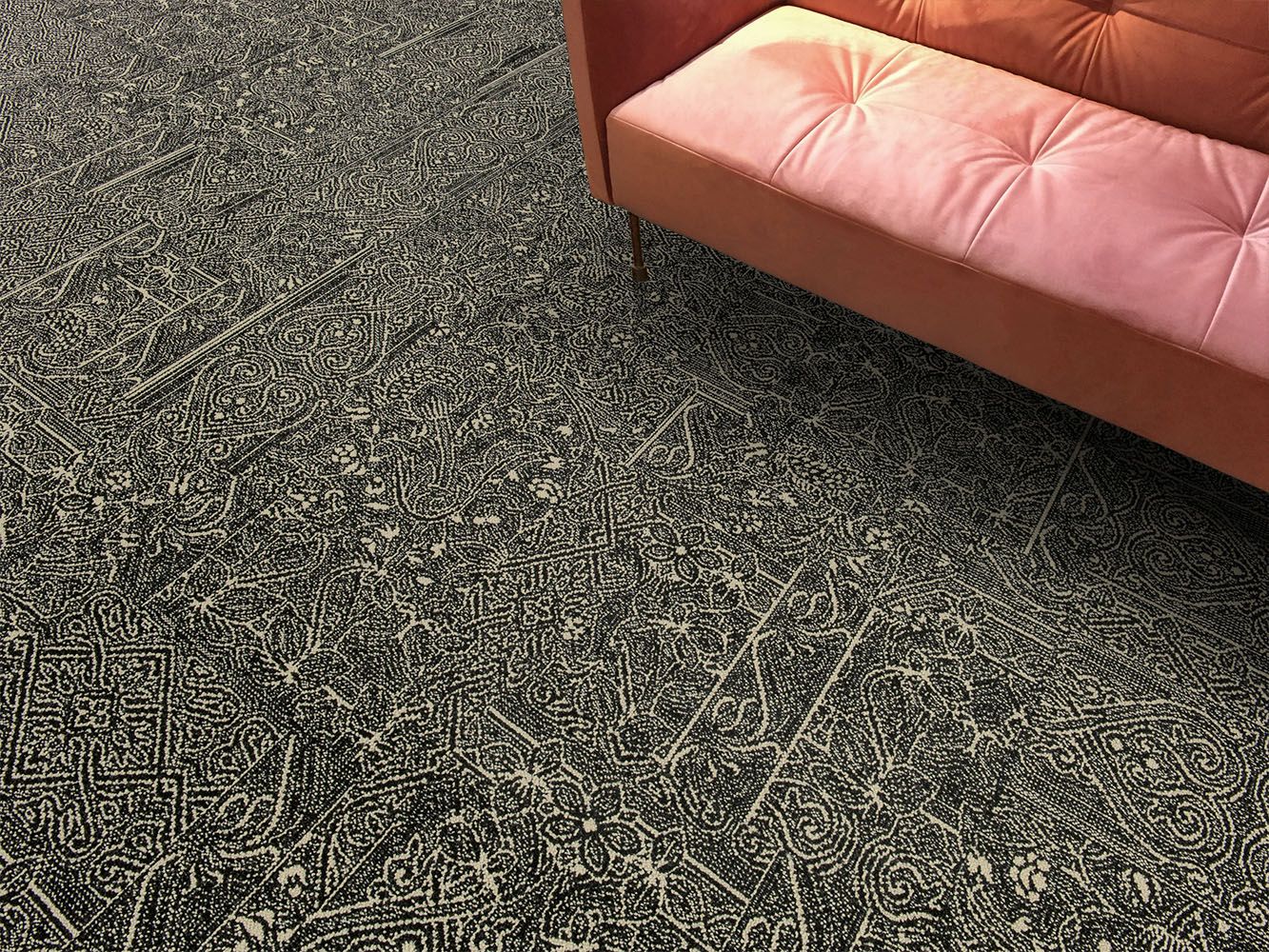 Detail of Interface DL924 carpet tile with salmon colored sofa image number 6